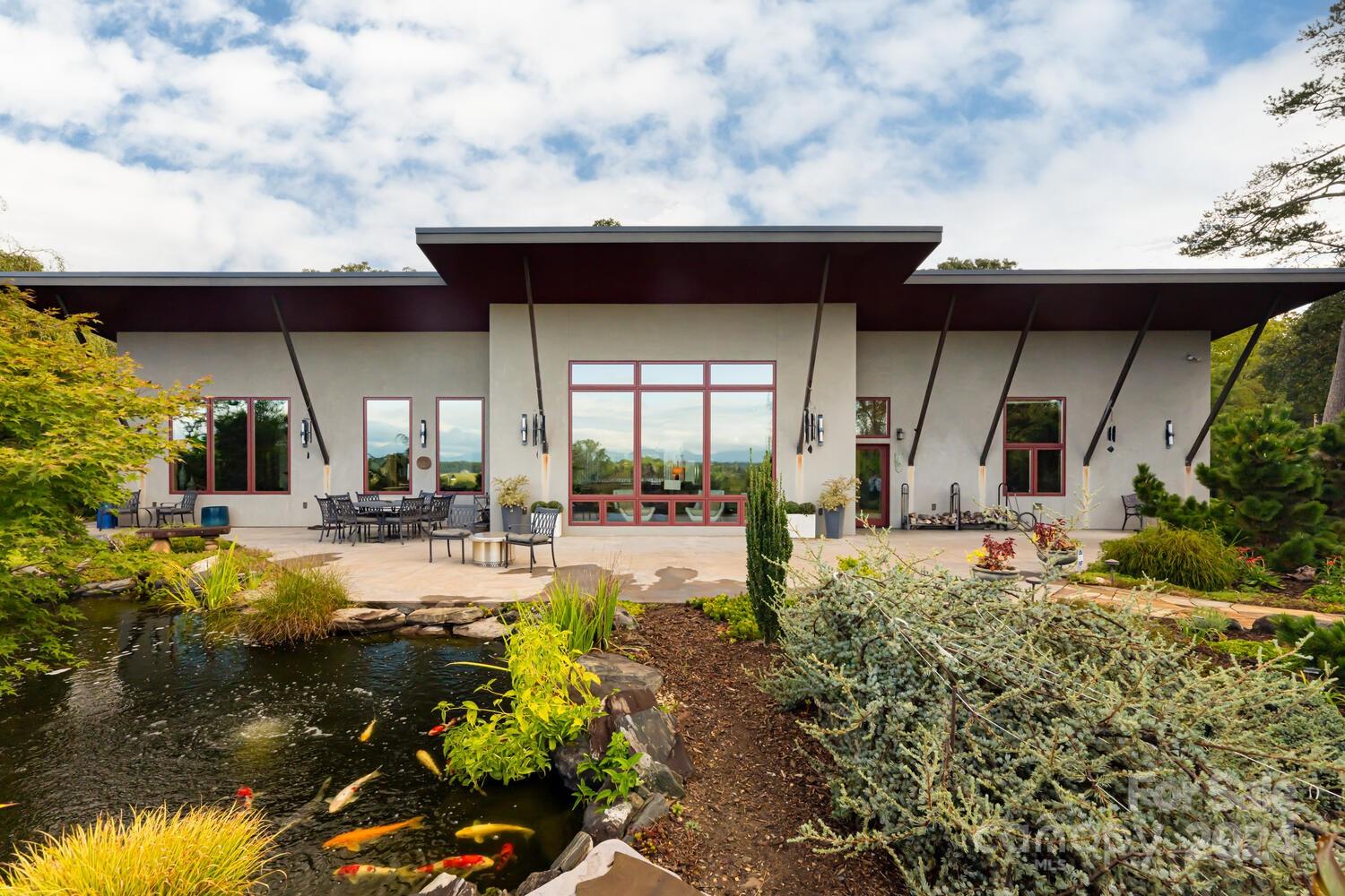 265 Alexander Road Alexander, NC 28701 - Photo 2 of 48 a view of a house with sitting area and garden