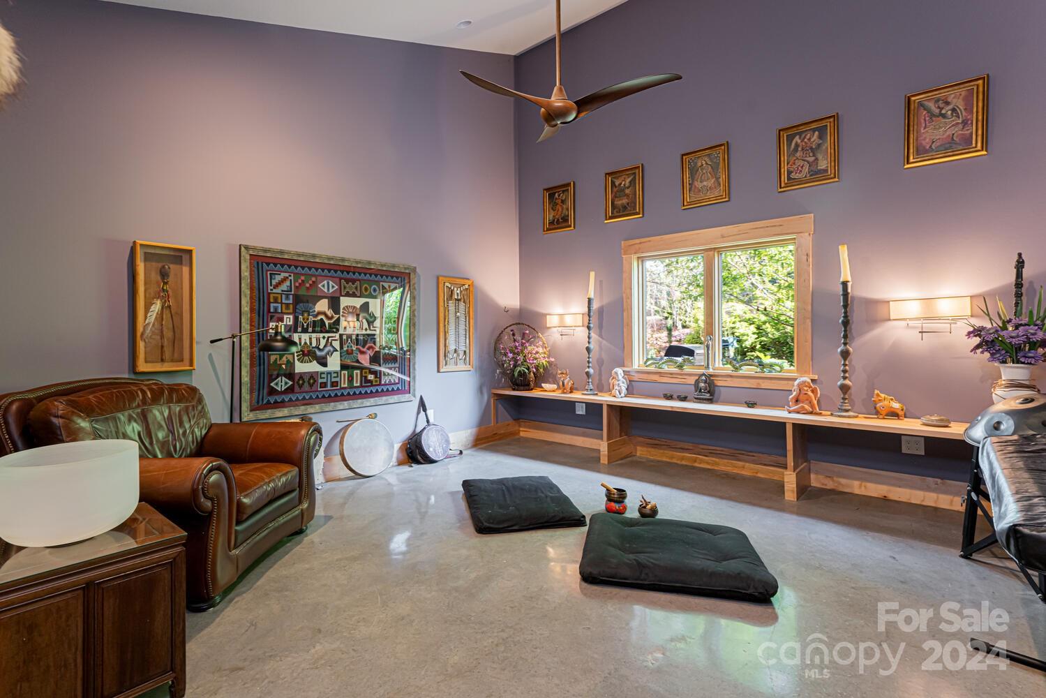 265 Alexander Road Alexander, NC 28701 - Photo 23 of 48 a living room with furniture gym equipment and a large window