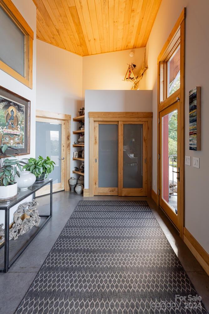 265 Alexander Road Alexander, NC 28701 - Photo 7 of 48 a view of a brick house with a large window and wooden fence
