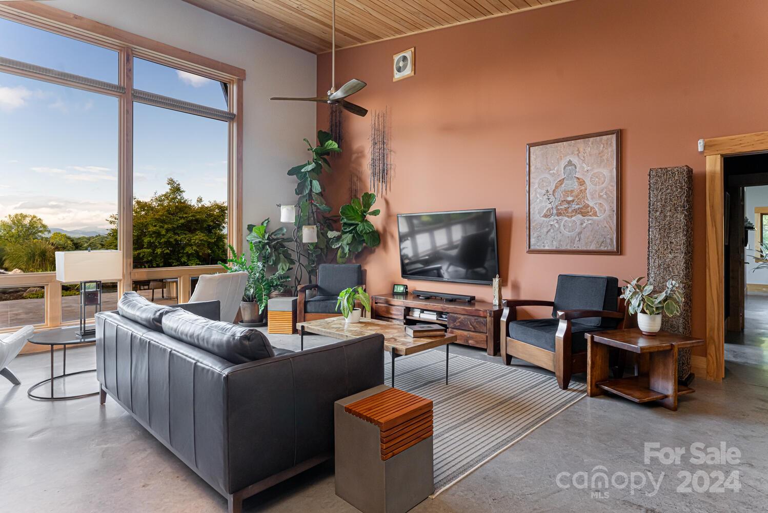 265 Alexander Road Alexander, NC 28701 - Photo 10 of 48 a living room with furniture and a flat screen tv