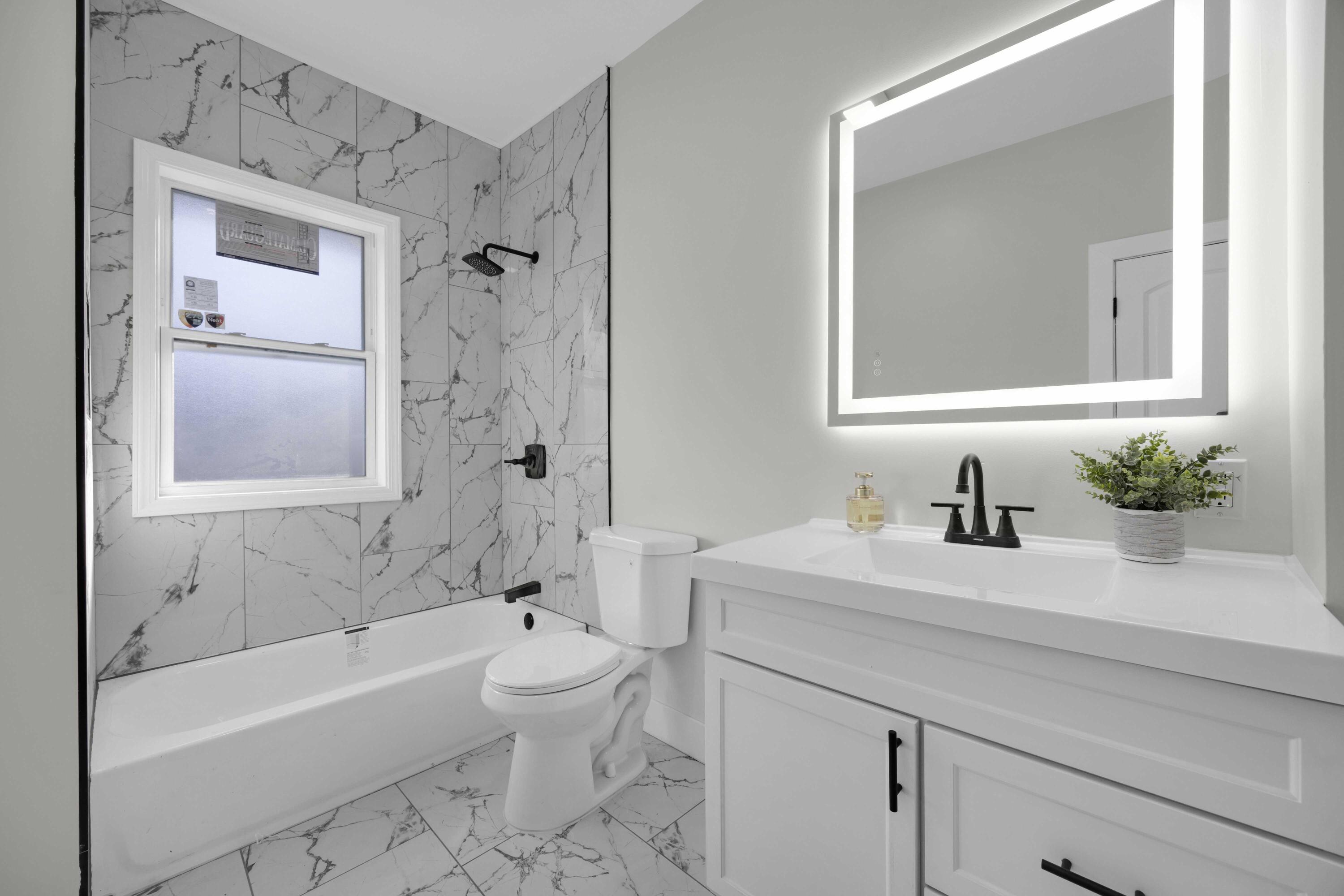 4200 Monroe Street Gary, IN 46408 - Photo 18 of 25 a bathroom with a sink a toilet and a bathtub