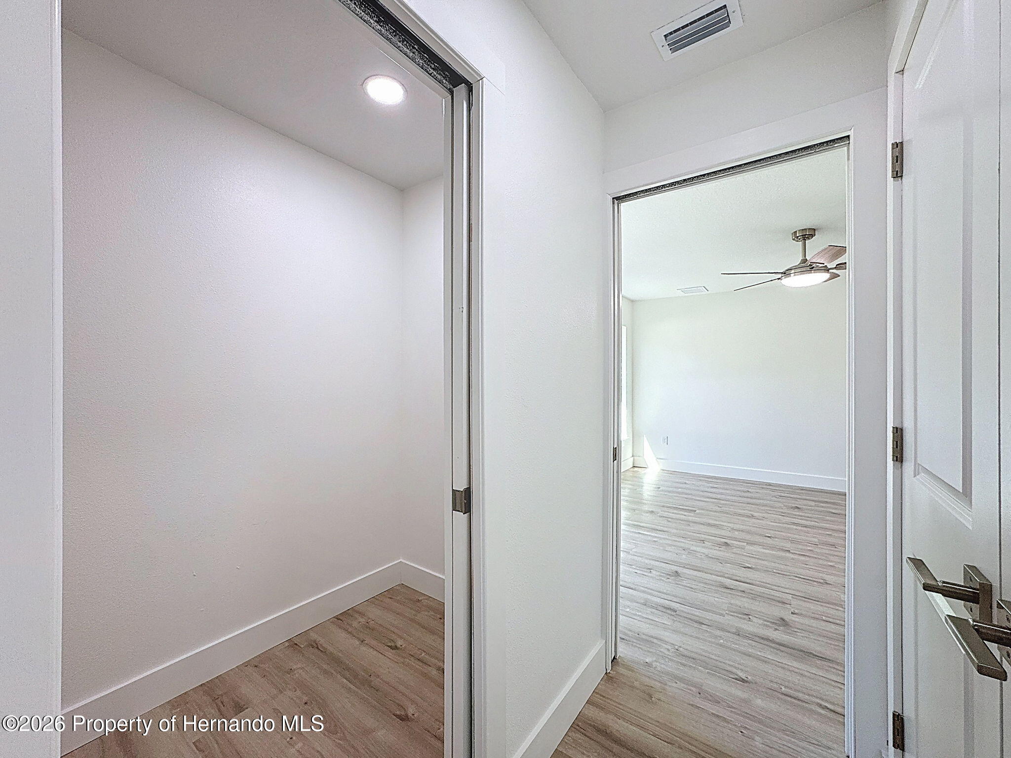 8988 Waterbird Way Weeki Wachee, FL 34613 - Photo 26 of 42 a view of hallway with wooden floor