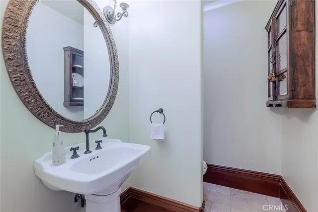 a bathroom with a granite countertop sink a toilet a mirror and shower