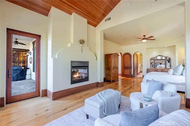 a living room with patio furniture and a fireplace
