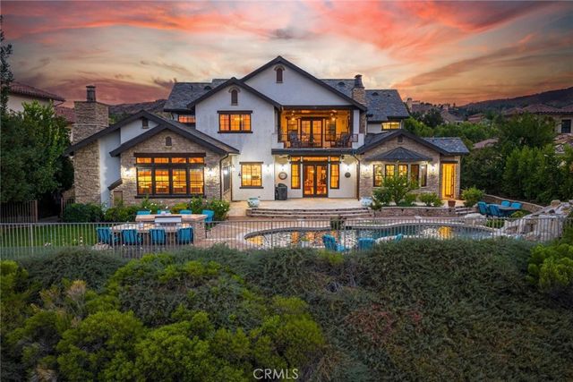 a front view of a house with a yard table and chairs