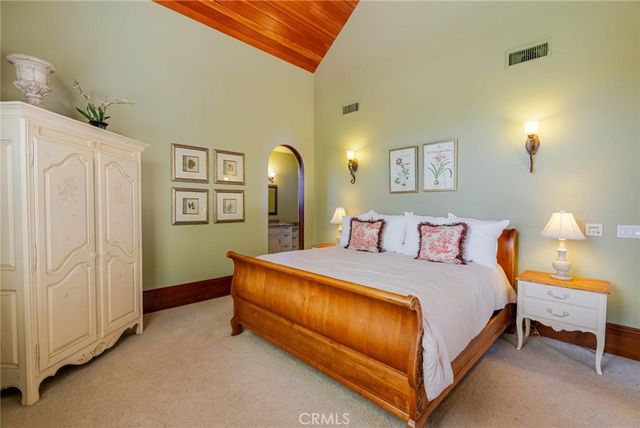 a bathroom with a granite countertop sink a toilet and a mirror