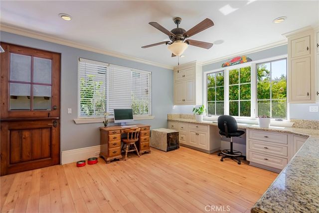 a bedroom with a bed and two windows