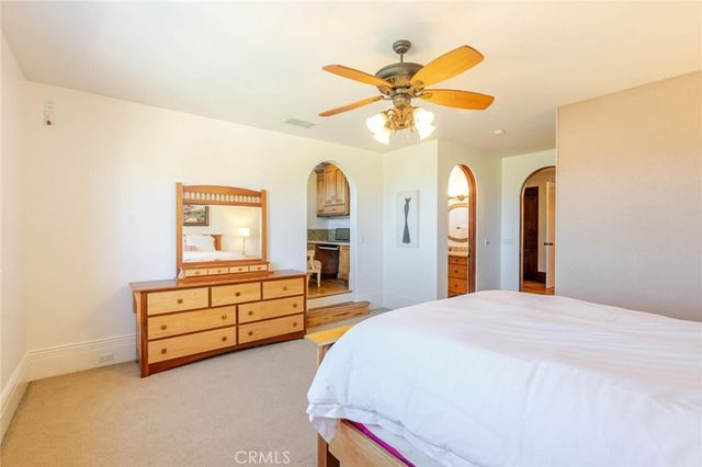 a view of a chair and table in backyard of the house