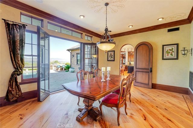 a large kitchen with stainless steel appliances granite countertop a lot of counter space and wooden floors