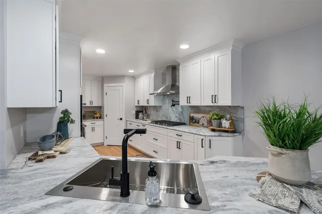a kitchen with a table chairs appliances and cabinets
