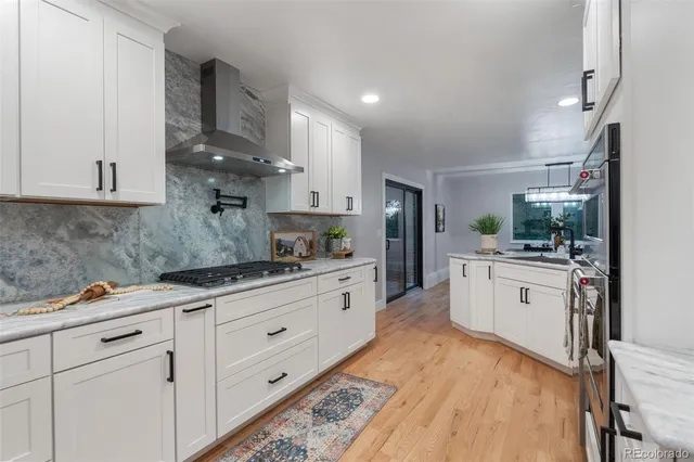 a kitchen with granite countertop white cabinets and white appliances