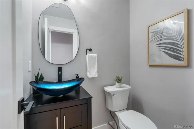 a bathroom with a toilet a sink and a mirror
