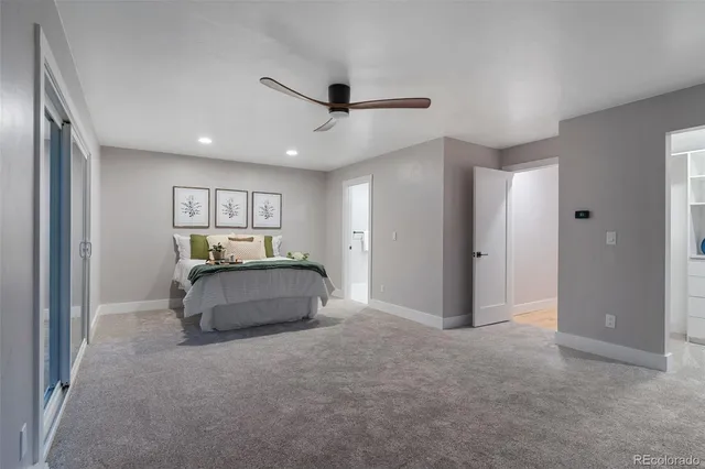 a living room with furniture and a ceiling fan