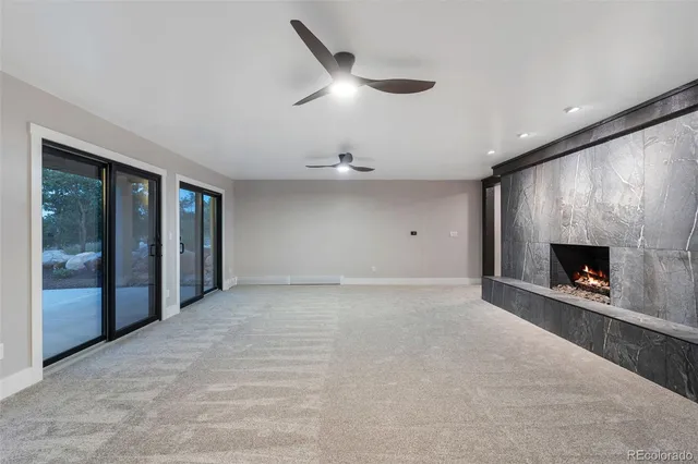 an empty room with fireplace and fan