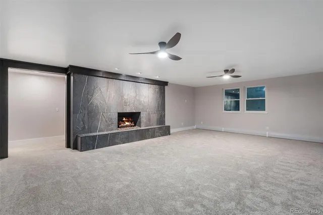 a view of an empty room with a fireplace and a window
