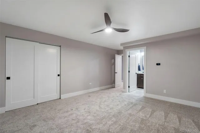 a view of an empty room and a ceiling fan