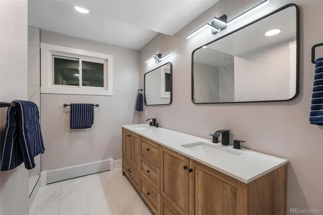 a bathroom with a double vanity sink a and mirror