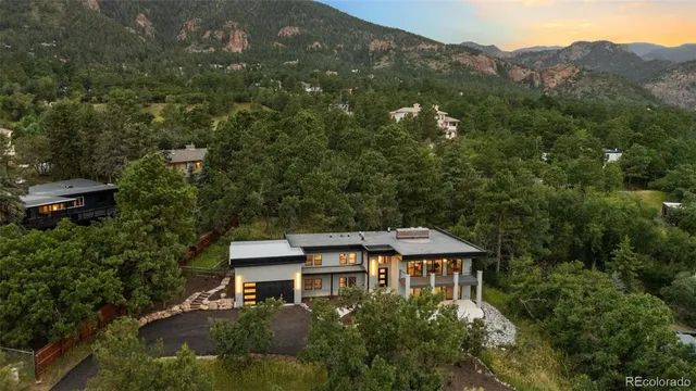 an aerial view of a house with a yard and balcony