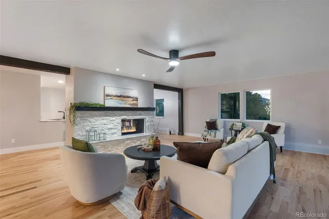 a living room with fireplace furniture and a wooden floor