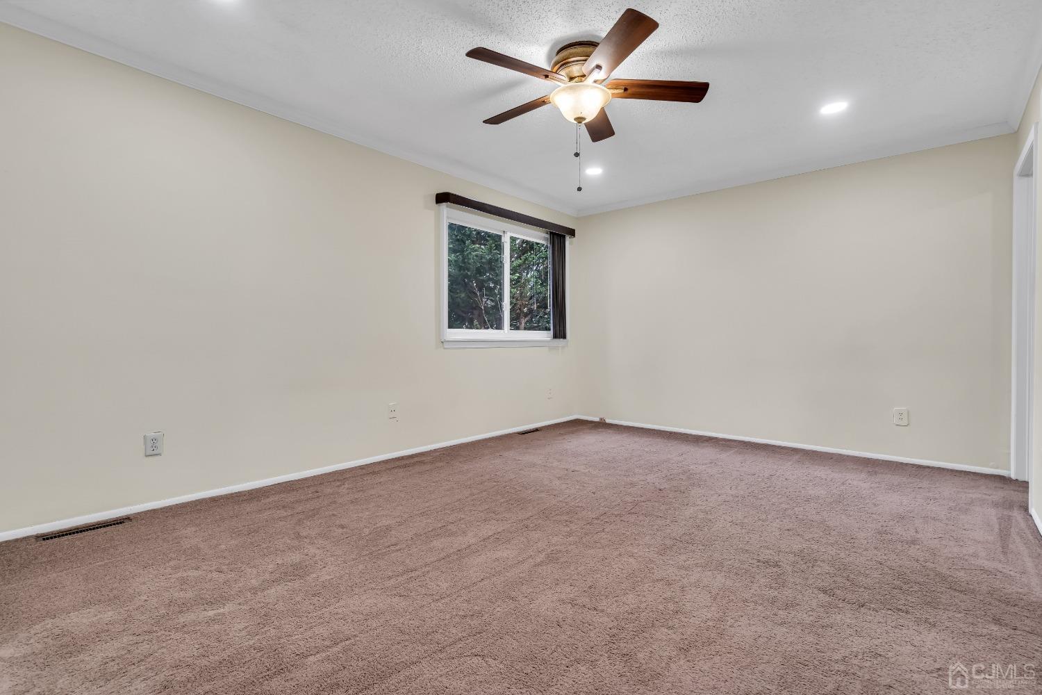 5507 Hana Road Edison, NJ 08817 - Photo 33 of 49 an empty room with a window and a fan