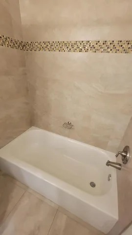 a bathroom with a shower and a bath tub