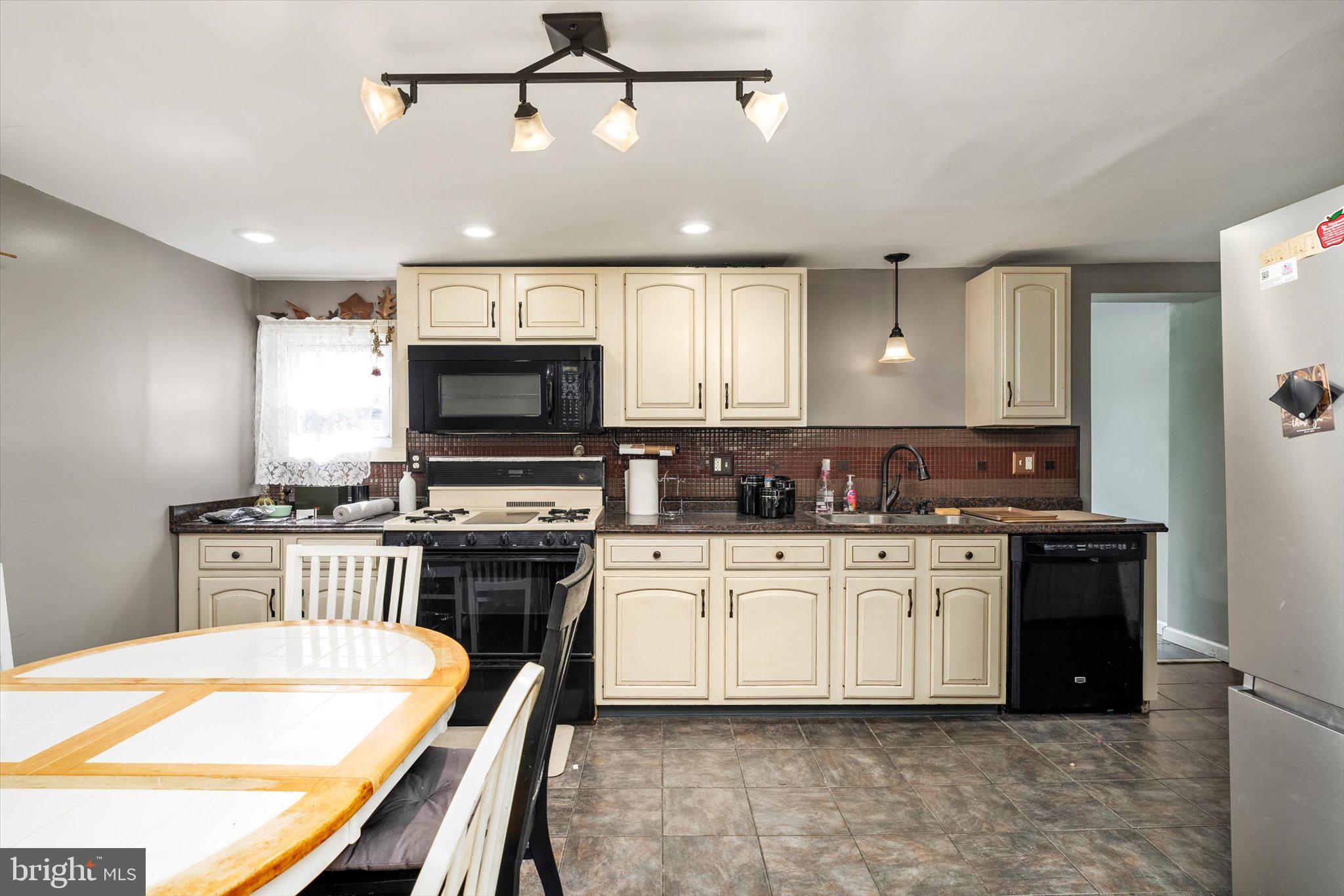 22 Brainerd Street Mount Holly, NJ 08060 - Photo 4 of 20 a kitchen with stainless steel appliances granite countertop a stove top oven a sink a stove and a refrigerator