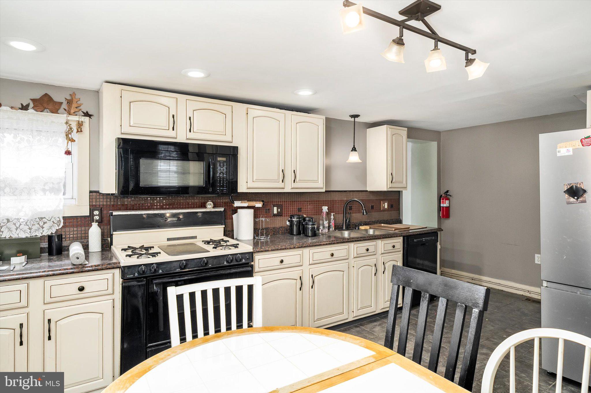 22 Brainerd Street Mount Holly, NJ 08060 - Photo 5 of 20 a kitchen with granite countertop a sink stainless steel appliances and white cabinets