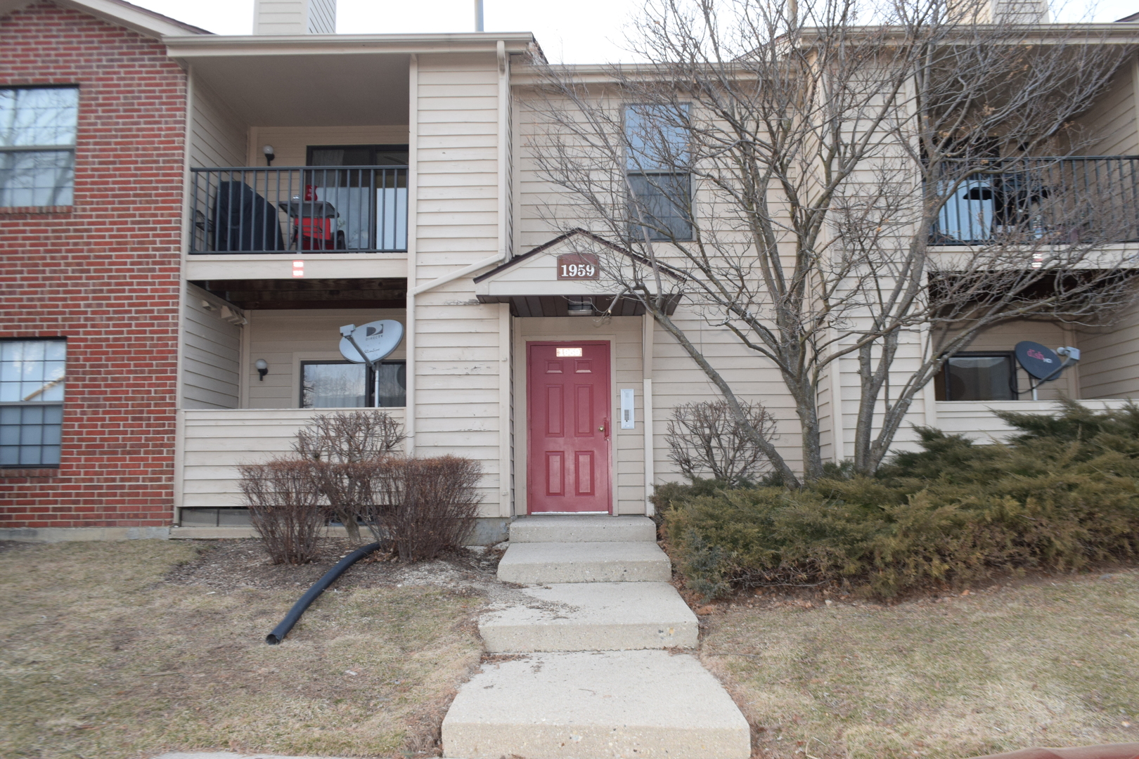 1959 North Hicks Road, Unit 103 Palatine, IL 60074 - Photo 1 of 22 a front view of a house with garden