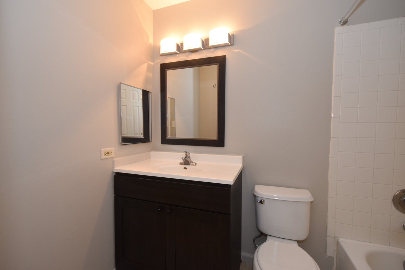 1959 North Hicks Road, Unit 103 Palatine, IL 60074 - Photo 11 of 22 a bathroom with a toilet sink and mirror
