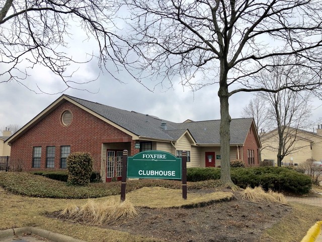 1959 North Hicks Road, Unit 103 Palatine, IL 60074 - Photo 19 of 22 a front view of a house with a yard and garage