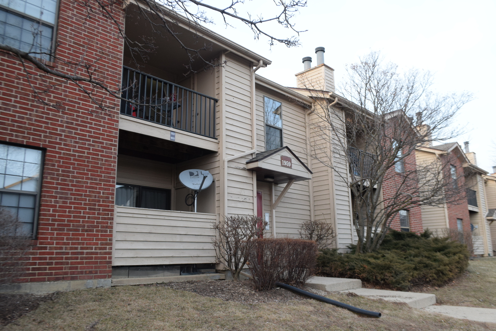 1959 North Hicks Road, Unit 103 Palatine, IL 60074 - Photo 3 of 22 a view of a house with a yard