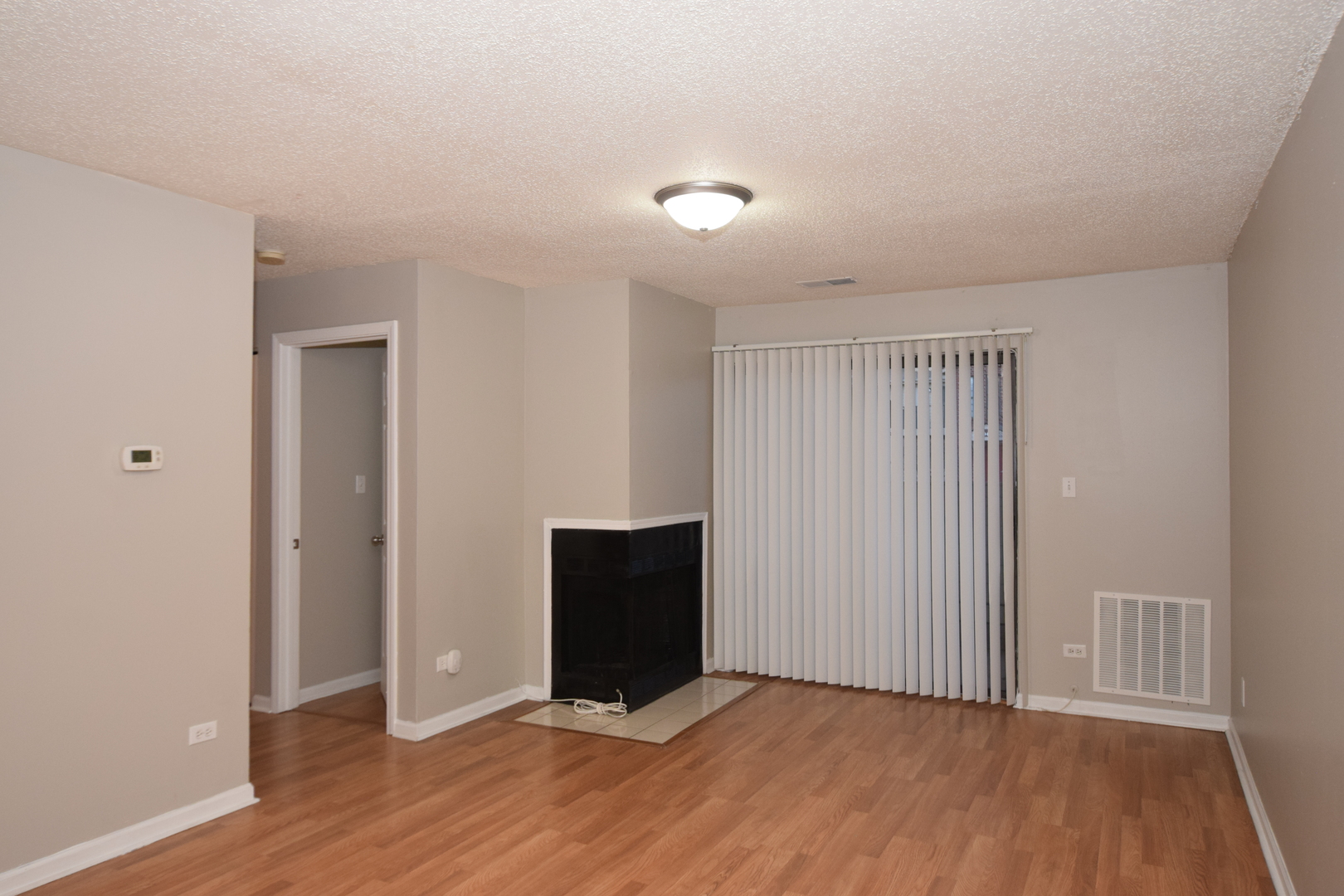 1959 North Hicks Road, Unit 103 Palatine, IL 60074 - Photo 4 of 22 a view of an empty room with wooden floor