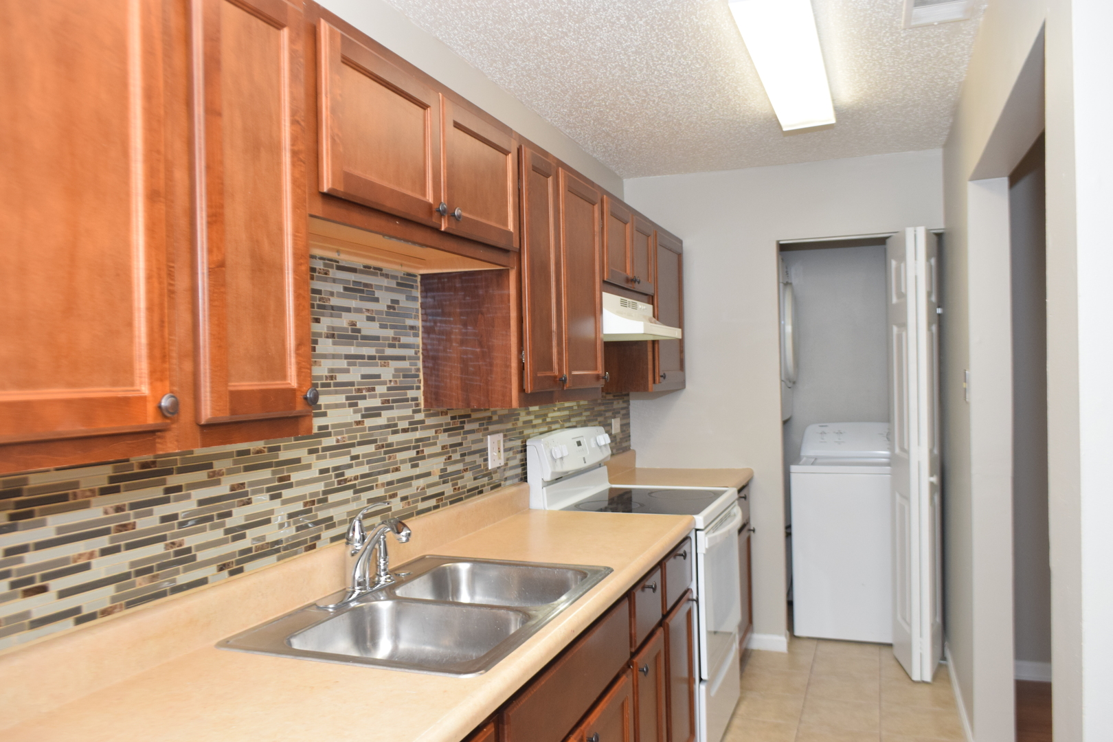 1959 North Hicks Road, Unit 103 Palatine, IL 60074 - Photo 6 of 22 a kitchen with stainless steel appliances granite countertop a sink and a wooden cabinets