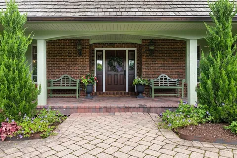 a front view of a house with garden