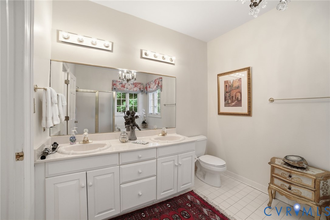 3950 Reeds Landing Circle Midlothian, VA 23113 - Photo 16 of 50 a bath room with a toilet a sink and a mirror