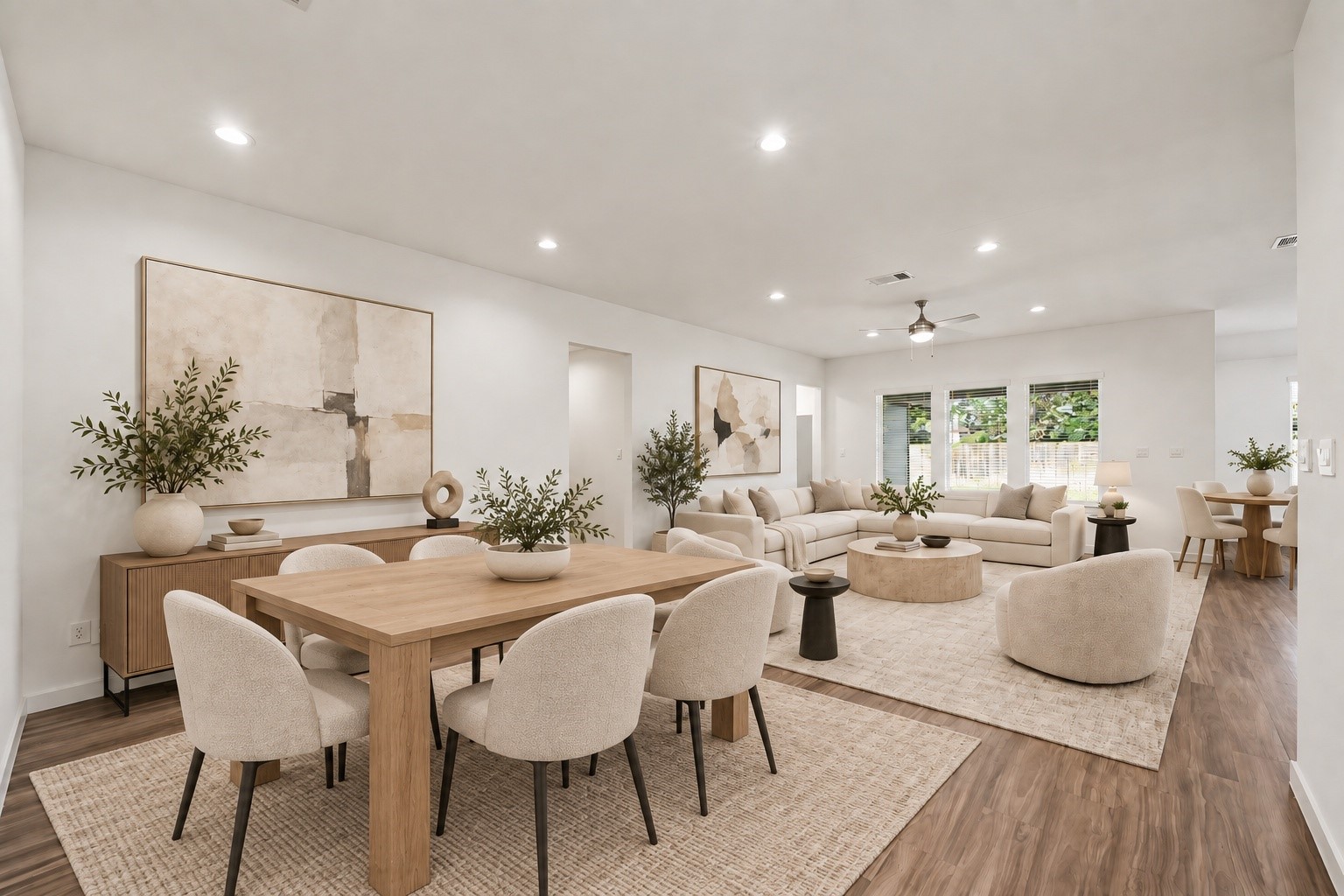 14162 Primrose Ridge Lane Conroe, TX 77384 - Photo 10 of 48 Experience modern elegance in this beautifully staged living and dining area, featuring stylish furnishings, warm wood accents, and abundant natural light, perfect for entertaining or relaxing.