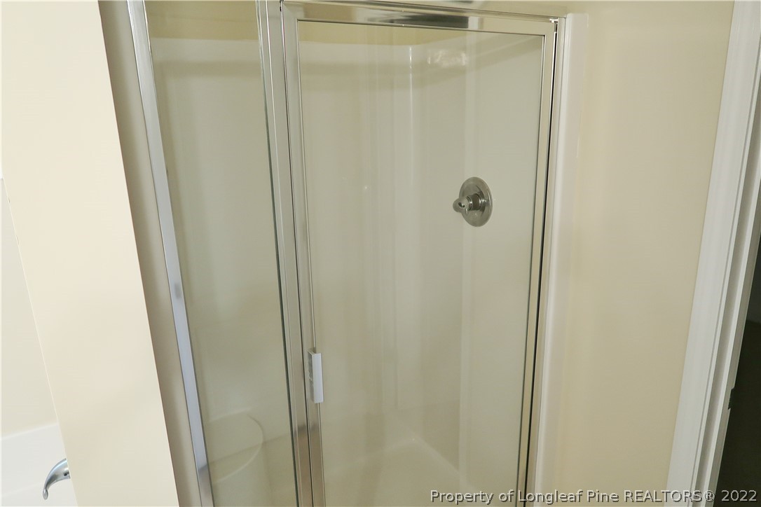 927 Montrose Road Raeford, NC 28376 - Photo 11 of 17 a bathroom with a glass shower door
