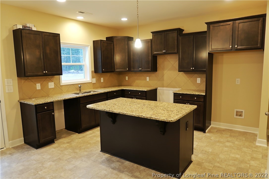 927 Montrose Road Raeford, NC 28376 - Photo 5 of 17 a kitchen with a refrigerator and a sink