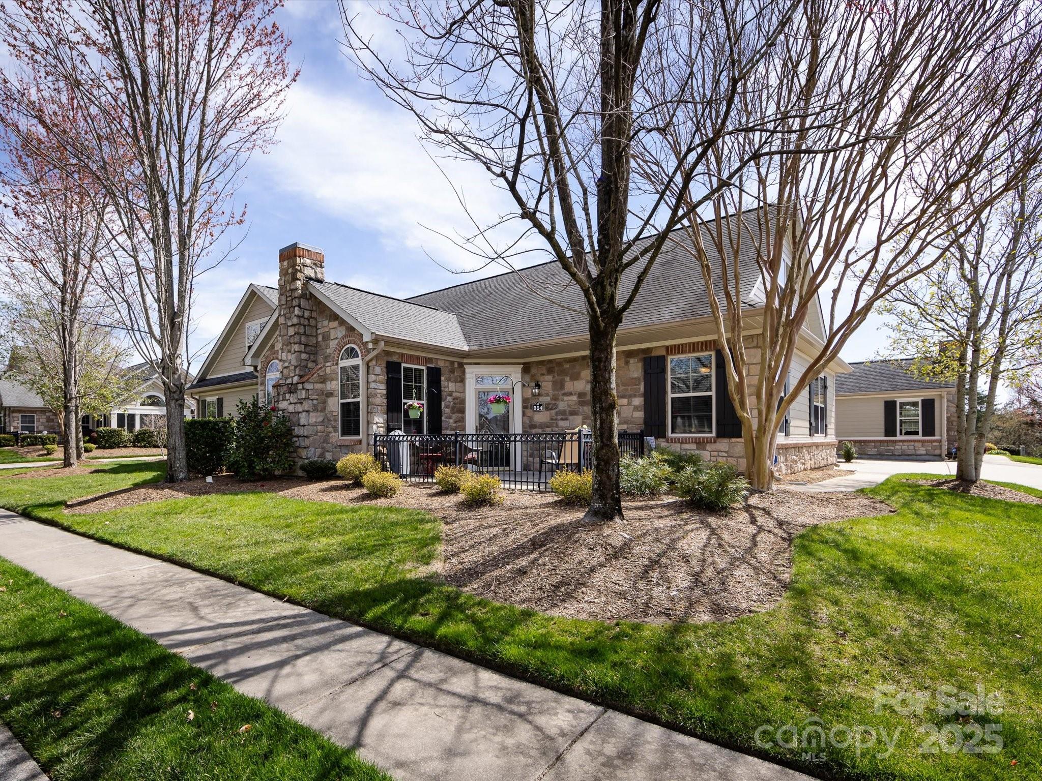 a front view of a house with yard patio and green space