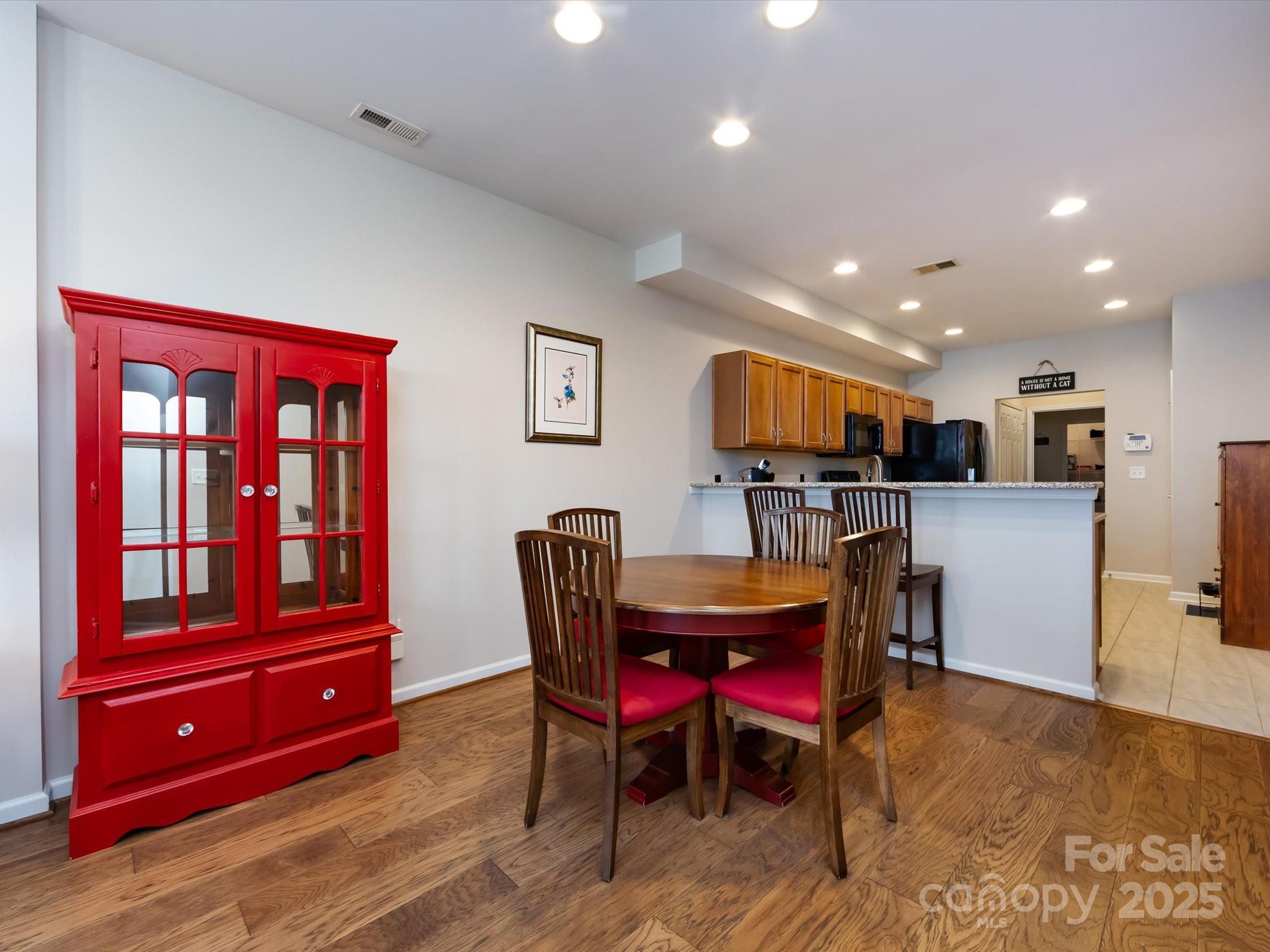 864 Ledgestone Court Fort Mill, SC 29708 - Photo 12 of 30 a living room with furniture and a dining table with wooden floor