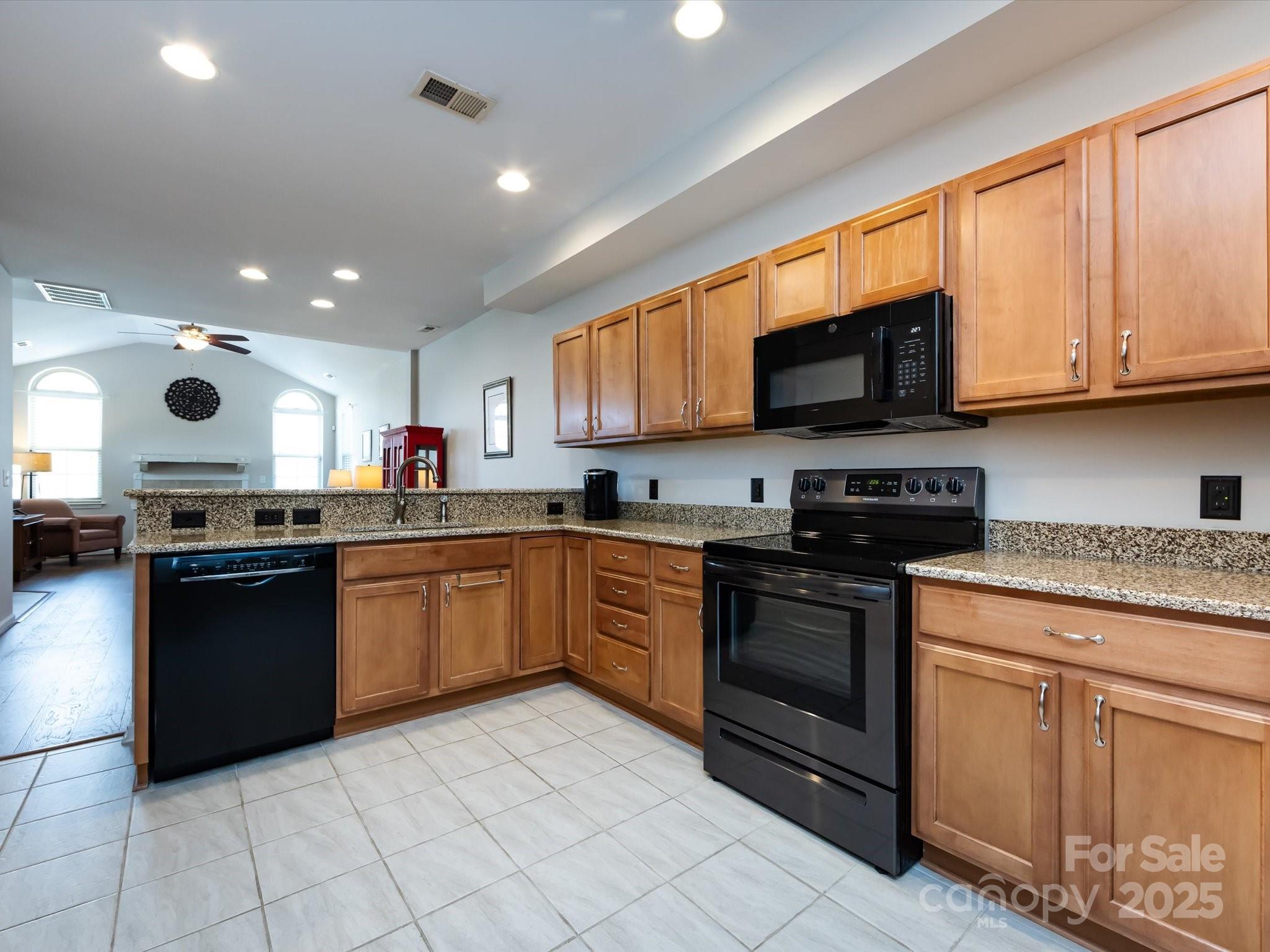 864 Ledgestone Court Fort Mill, SC 29708 - Photo 13 of 30 a kitchen with stainless steel appliances granite countertop a stove top oven a sink dishwasher and a microwave oven on the blue kitchen countertops