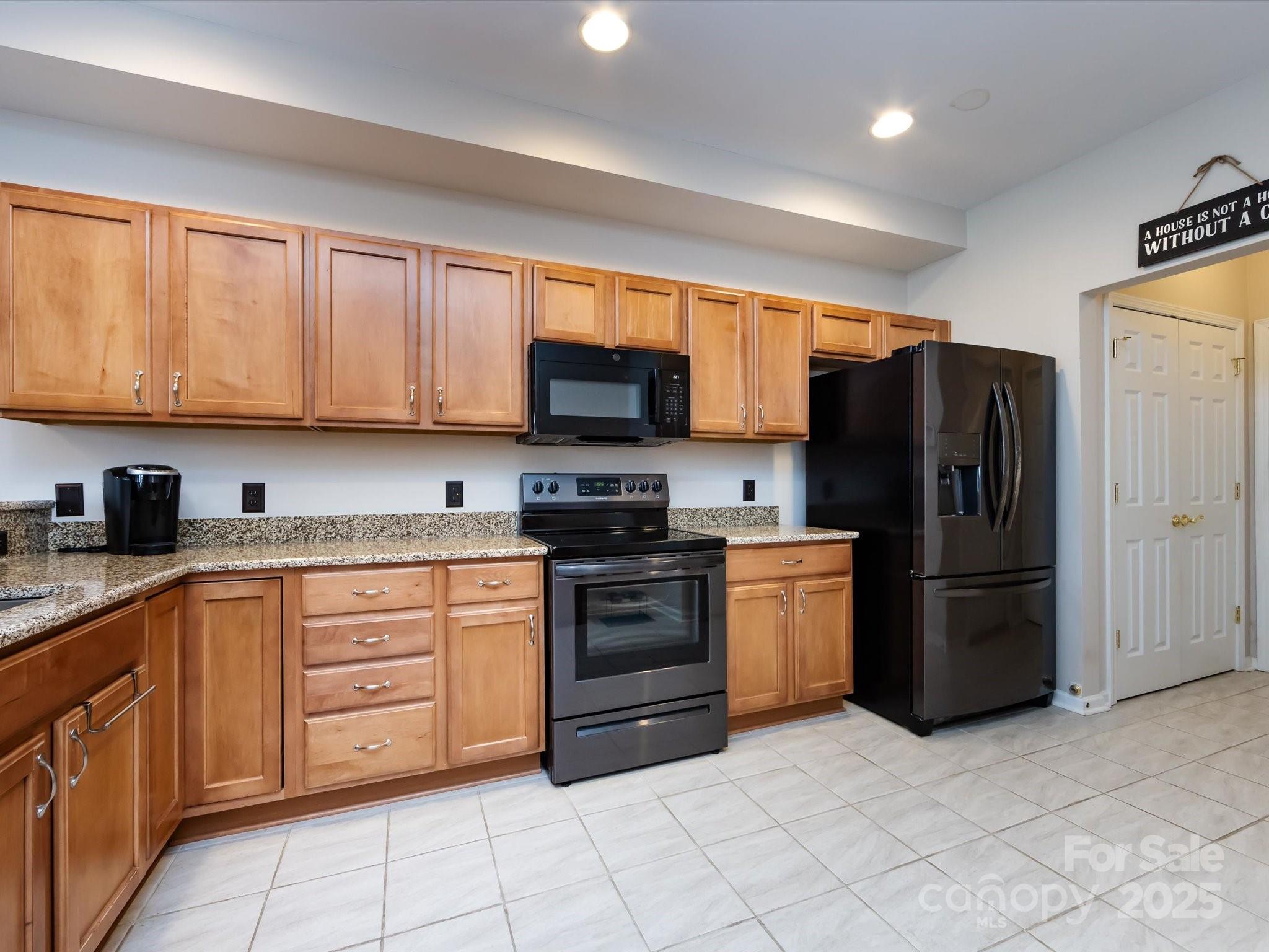 864 Ledgestone Court Fort Mill, SC 29708 - Photo 14 of 30 a kitchen with stainless steel appliances granite countertop a refrigerator stove and sink