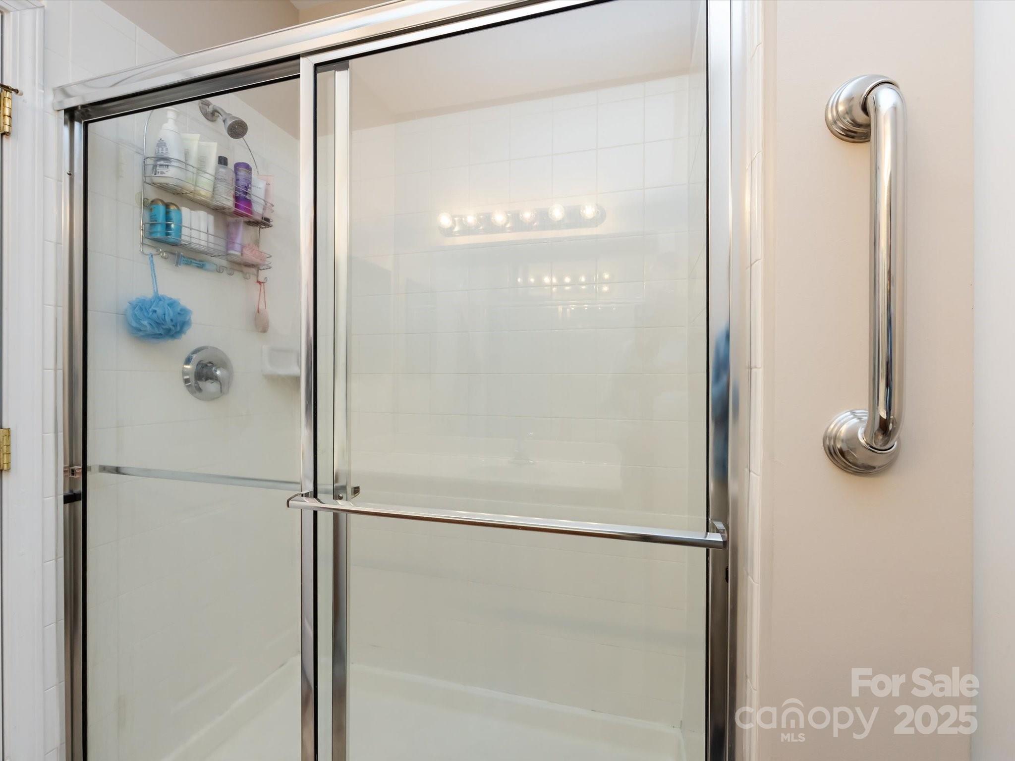 864 Ledgestone Court Fort Mill, SC 29708 - Photo 20 of 30 a bathroom with a glass shower door