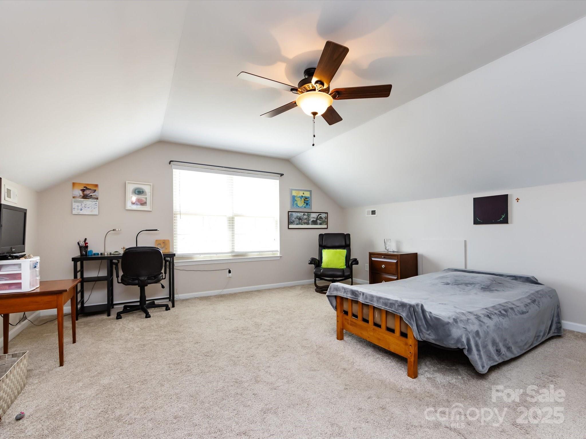 864 Ledgestone Court Fort Mill, SC 29708 - Photo 26 of 30 a bedroom with a bed a couch and a window