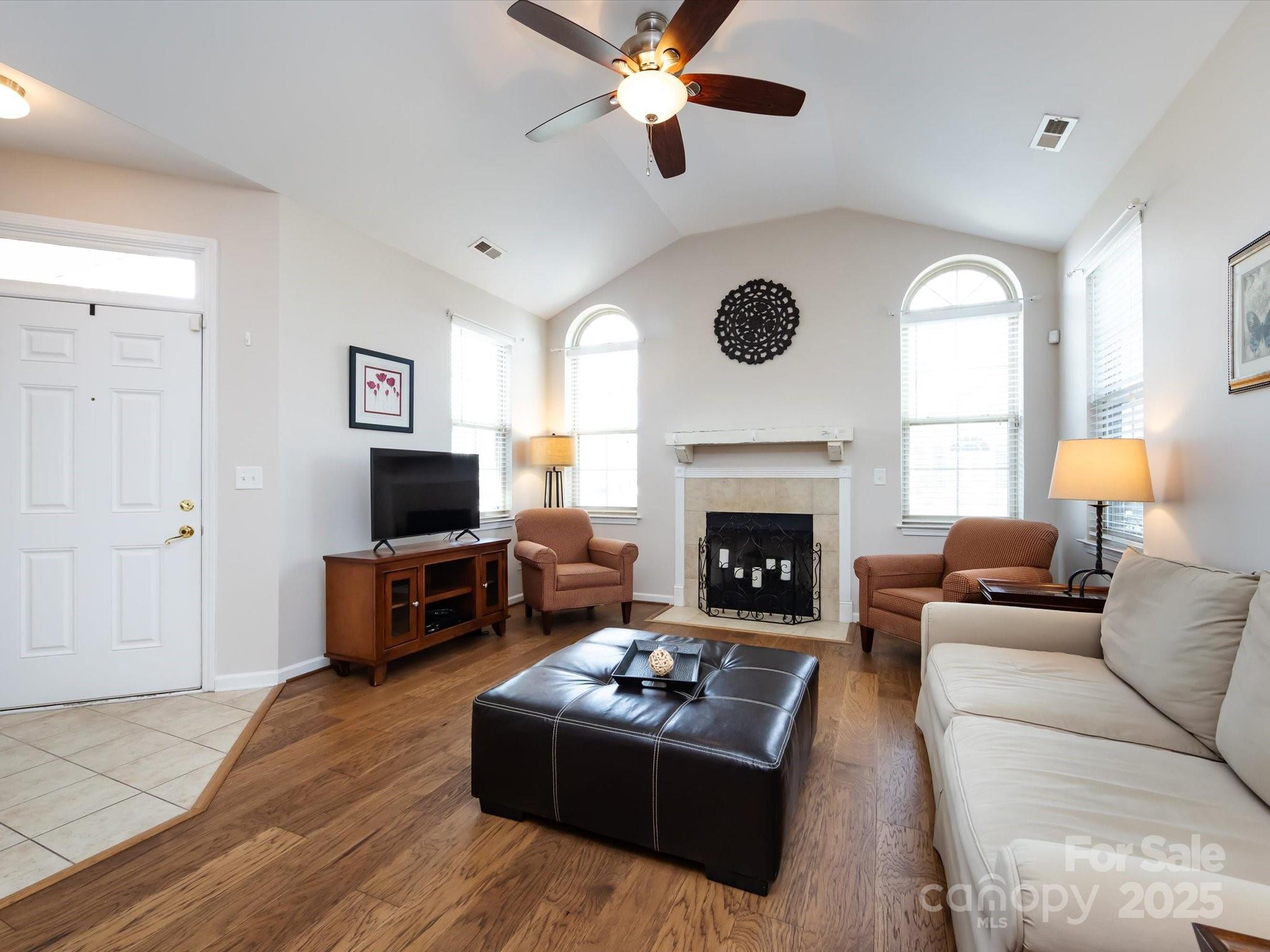 864 Ledgestone Court Fort Mill, SC 29708 - Photo 10 of 30 a living room with furniture a window and a fireplace