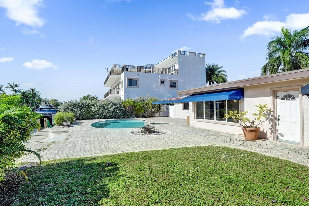 a front view of a house with a garden and patio