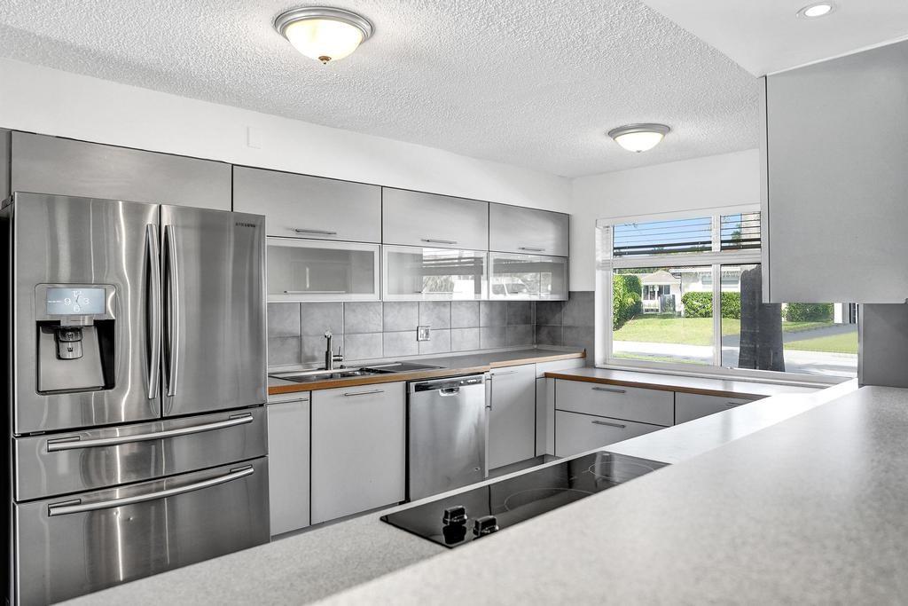 2632 Southeast 10th Court Pompano Beach, FL 33062 - Photo 11 of 49 a kitchen with stainless steel appliances granite countertop a refrigerator and a stove