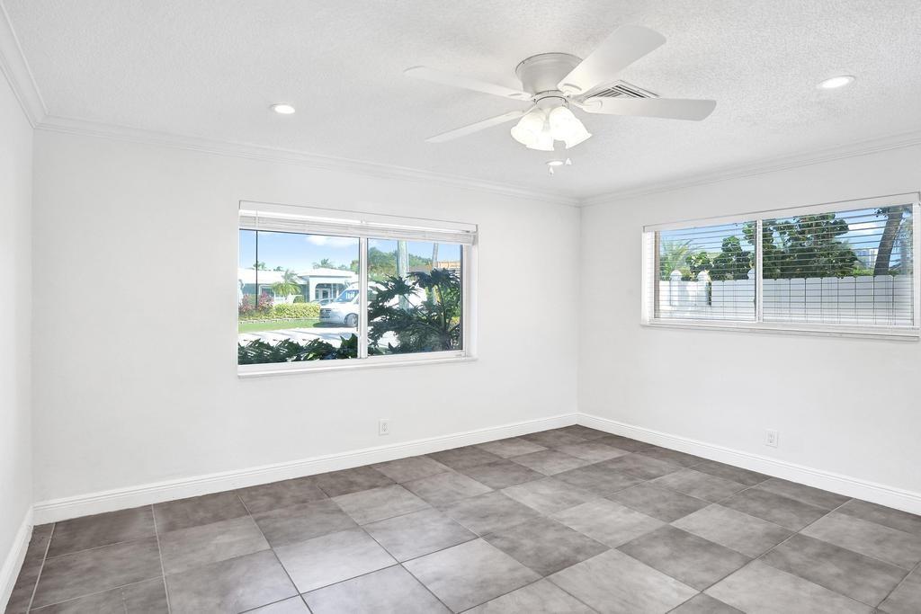 2632 Southeast 10th Court Pompano Beach, FL 33062 - Photo 23 of 49 an empty room with windows and chandelier fan