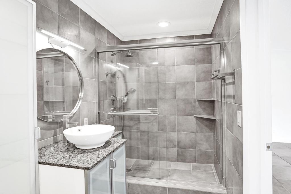 2632 Southeast 10th Court Pompano Beach, FL 33062 - Photo 28 of 49 a bathroom with a granite countertop shower sink and mirror