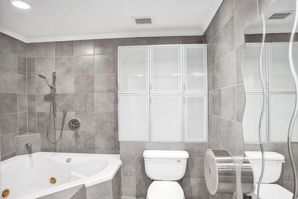 2632 Southeast 10th Court Pompano Beach, FL 33062 - Photo 29 of 49 a bathroom with a bathtub toilet and shower